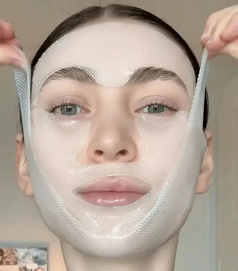 A person applying a white mesh face mask.